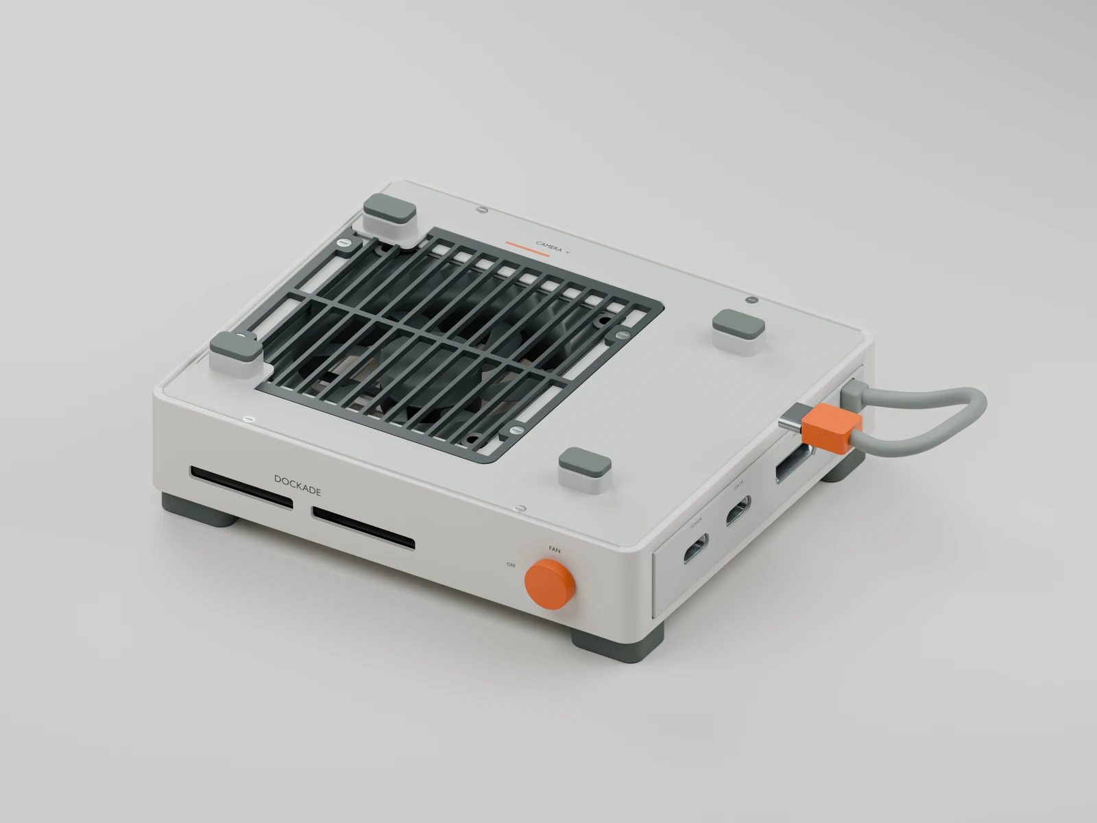Dockade V11 open-top dock concept with a graphite grille, four low gray silicone pads, circular orange fan dial and attached USB-C host lead.
